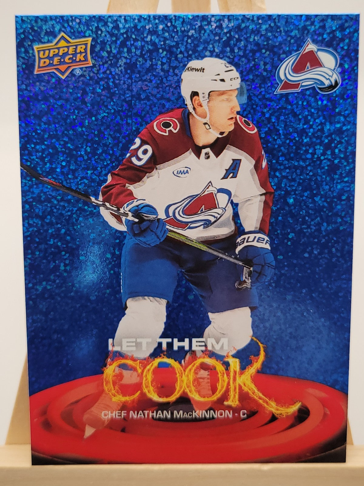 2025-26 Upper Deck Nathan MacKinnon Blue trading card, front